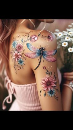 a woman with tattoos on her body and flowers