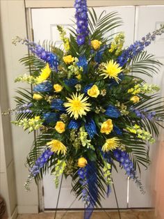 a blue and yellow arrangement in front of a door