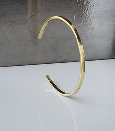 "18k Solid Gold Hand Forged Cuff Bracelet, 18k Gold Cuff Bracelet. Solid Gold Cuff. Hammered Gold Cuff. Recycled Gold Jewelry 3 mm wide Men's - Women's - Unisex Bangle: Handmade Material: 18k Solid Gold crafted by hand and made with love.  Great for stacking or stand alone Surface/ Profile: Smooth Inner surface/ profile: Smooth Made from recycled 18k solid gold rich warm yellow gold. This gives it an added luminosity and glow that makes it stand out. The edges are smooth  with an overall matte finish. Choose Sizing: -Small is 5.5\" long, fits wrists about 6\" if measured with a string - Medium is 6\" long, fits wrists about 6.5\" circumference, fits most women. - Large is 6.5\" long, fits wrists about 7\" circumference. -XLarge is 7\" long, fits wrists about 7.5\" ( average size of a man's Solid Gold Cuff Bracelet, Recycled Gold Jewelry, Gold Cuff Bracelet, Hammered Band, Warm Yellow, Gold Bracelet Cuff, Gold Hand, Hammered Gold, Gold Cuffs