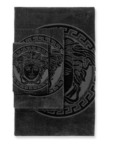 two black towels with an image of a lion in the center and a circle around it