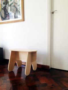 a small wooden table sitting on top of a hard wood floor