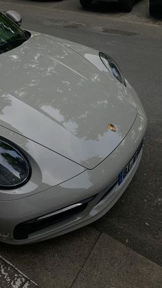 a silver sports car parked on the side of the road