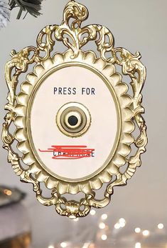 an ornament hanging from the ceiling with champagne glasses in front of it and candles on the table