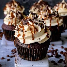 chocolate cupcakes with white frosting and caramel drizzle on top