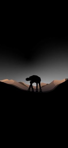 two people are walking in the desert at night, with mountains and hills behind them