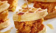 fried chicken and waffles on a plate with syrup drizzled over them