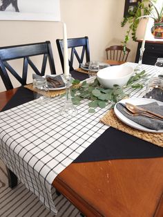 a dining room table set with place settings