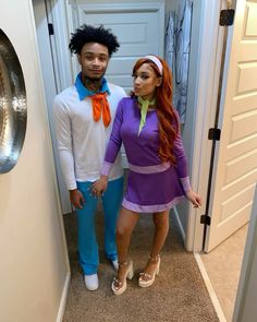 a man and woman dressed up in costume standing next to each other on the hallway