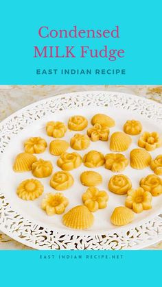 a white plate topped with lots of yellow cookies on top of a blue and white table