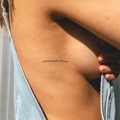 a woman's stomach with the word mom written on it, in cursive font