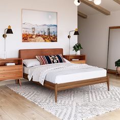 a bedroom with white walls and wood furniture