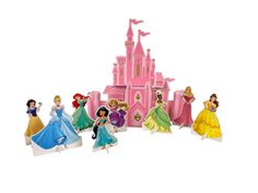 disney princess figurines are lined up in front of a castle