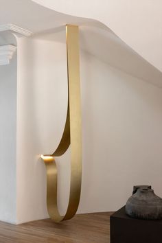 an abstract sculpture in the corner of a room