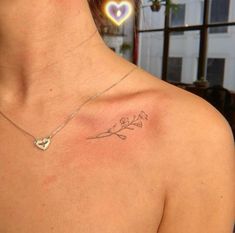 a woman with a small tattoo on her chest