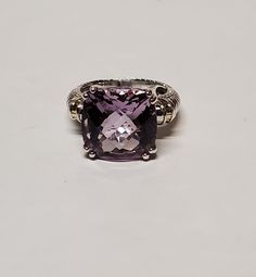 925 Sterling Silver 14 mm Princess Cut Faceted Amethyst Brutalist Ring Size 7 VERY GOOD CONDITION Metal: 925 Sterling Silver Weight : 9 Grams Stone : Amethyst   Stone Size 14x14 mm approximately Unique and handcrafted, actual item pictured. Please read the full description, terms and review all pictures BEFORE purchasing. Any question, please do not hesitate to contact us. International Shipping Varies by Country. YOUR SUPPORT IS GREATLY APRECIATED, THANK YOU! Luxury Purple Sterling Silver Ring, Classic Silver Amethyst Ring With Gemstone Accents, Fine Jewelry Amethyst Ring With Accent Stones In Silver, Fine Jewelry Silver Amethyst Ring With Accent Stones, Silver Amethyst Ring With Accent Stones, Formal Amethyst Ring In Sterling Silver, Vs Clarity, Silver Amethyst Ring With Accent Stones For Formal Occasions, Elegant Purple Rings Stamped 925, Formal Purple Crystal Sterling Silver Ring