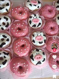 a box filled with lots of pink and white frosted donuts