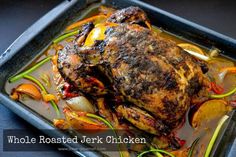 whole roasted chicken with vegetables in a pan