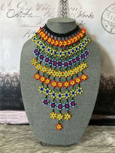 All our pieces are genuine and each chaquira is handcrafted by artisans from the most representative areas of Huichol art. We only have one piece of each style, choose the option or style that you like and only choose 1 quantity, thank you. The necklace measures approximately 13in long.Bears approximately 85 to 88 flowers. Flower Waterfall, Waterfall Necklace, Necklace Set With Earrings, Huichol Art, Flower Choker, Star Flower, Choker Necklaces, Bead Weaving, Matching Earrings