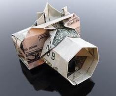 an origami house made out of one dollar bill and another piece of paper