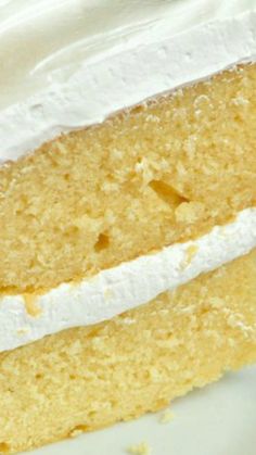 a close up of a slice of cake with white frosting