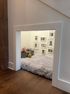 a dog bed in the corner of a room with pictures on the wall