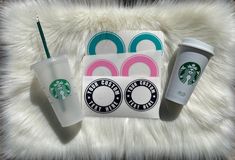 starbucks coffee cups and coasters sitting on a furry surface