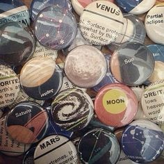 a bunch of buttons that are sitting on top of each other in the shape of planets