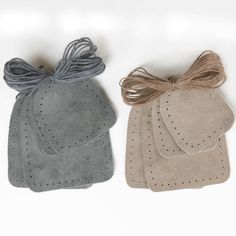 three pairs of oven mitts with bows on the front and back of each pair