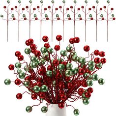 a white vase filled with red and green ornaments