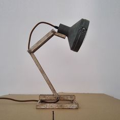 a desk lamp sitting on top of a wooden table