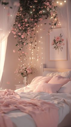 a bedroom with pink flowers hanging from the ceiling and lights on the wall above it