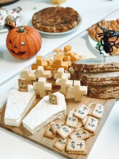 cheese and crackers are arranged on a cutting board