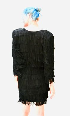 "super fun 80s does 20's inspired fringe dress: * Constructed in black knit jersey for comfy fit * Fringe on the whole body * Elbow Length sleeves * Structured padded shoulders * Used vintage condition, the fringe is frayed on some ends and has been cleaned. By CM Larfra NYC couture No Size, like a Small Medium 100% polyester jersey (With a bit fo stretch) Bust 33-40\" Hips 36-44\" Length from high point of shoulder 34\" All measurements are given in full. Thank you for visiting Hooked On Honey, Black Flapper Dress With Fringe For Evening, Black Fringe Flapper Dress For Evening, Black Fringe Flapper Dress For Night Out, Black Fringe Mini Dress For Party Season, Evening Black Flapper Dress With Fringe, Black Fringe Mini Dress For Cocktail, Black Fringe Flapper Dress, Black Tassel Mini Dress For Party, Black Mini Dress With Tassels For Party