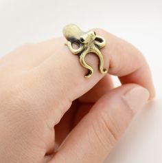 • Handcrafted Wrap Rings – Wear Felicity octopus wrap ring are carefully designed by jewelry artists to ensure they’re stylish and durable. They’re the perfect addition for animal lovers everywhere.• Classic, Intricate Detailing – Each small wrapped ring features the “octopus”, a octopus that is peering over your finger to remind you how much he loves you! • Wonderful Gift Choice – Animal wrap rings make a great birthday, anniversary, holiday, or “just because” gift for special women and girls i Animal Themed Jewelry, Octopus Ring, Funky Rings, Baby Octopus, Ocean Inspired Jewelry, Jewelry Beach, Ocean Jewelry, Crystal Eye, Animal Rings