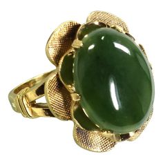 1940s designer Clark & Coombs gold-filled cocktail ring. A three-dimensional design of textured scallops surround an oval cabochon of apple jade; shoulders are split-shank with crossbars. Expressive of the Forties' obsession with oriental motifs, this beautifully-crafted offering is from one of the pre-eminent ring designers of the time. Clark and Coombs were renowned for their creative designs and exquisite workmanship, and this ring is a stunning example. The setting is in perfect harmony with Green Cocktail, Gold Cocktail Ring, Gold Cocktail, Jade Ring, Perfect Harmony, Split Shank, Jade Stone, Garnet Rings, Asian Style