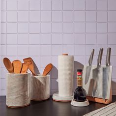 kitchen utensils and wooden spoons on a counter