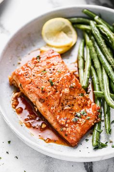 honey garlic salmon and green beans on a white plate with the title overlay reads honey garlic salmon