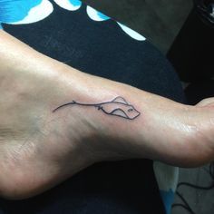 a foot with a small fish tattoo on it's left side and the word love written in black ink