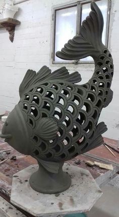 a fish sculpture sitting on top of a wooden table