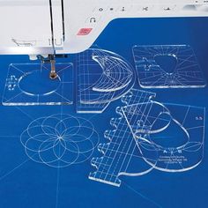 the sewing machine is next to some blueprints