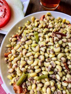 a white plate topped with beans and vegetables