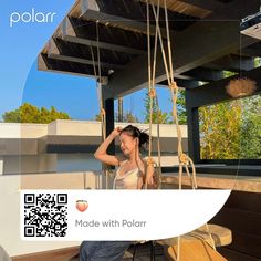 a woman sitting on top of a wooden bench in front of a building with a qr code attached to it