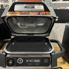 an open grill on top of a counter in a room with other items around it