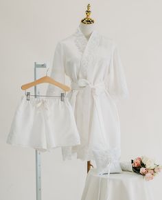 a white robe and dress sitting on top of a table