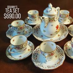 a table topped with lots of tea cups and saucers