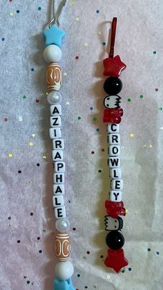 two toothbrushes decorated with letters and bows