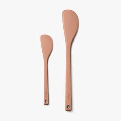 two wooden spoons sitting next to each other