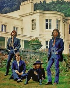 the doors pose in front of a large house