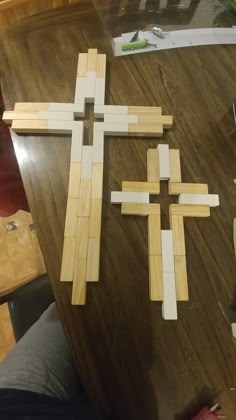 several pieces of wood laid out on a table to make a cross shape with sticks