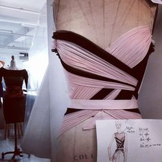 a dress on display in a room with mannequins